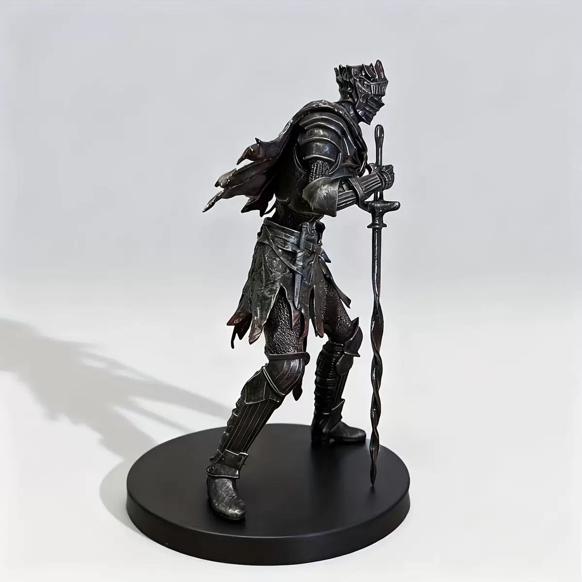 Dark fantasy armored knight figure with coiled sword and round display base